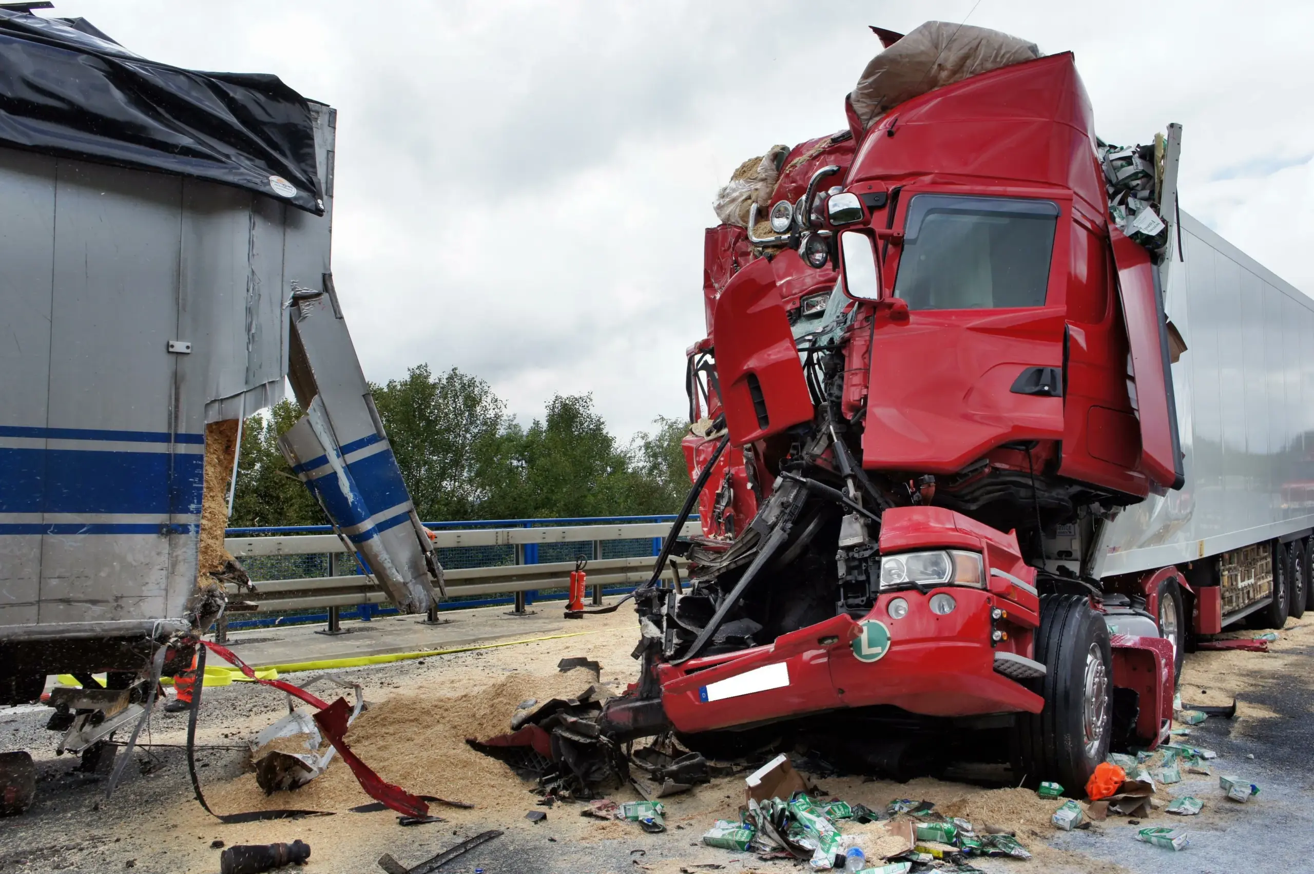 The aftermath of a bad truck accident, with the front and back both destroyed. 