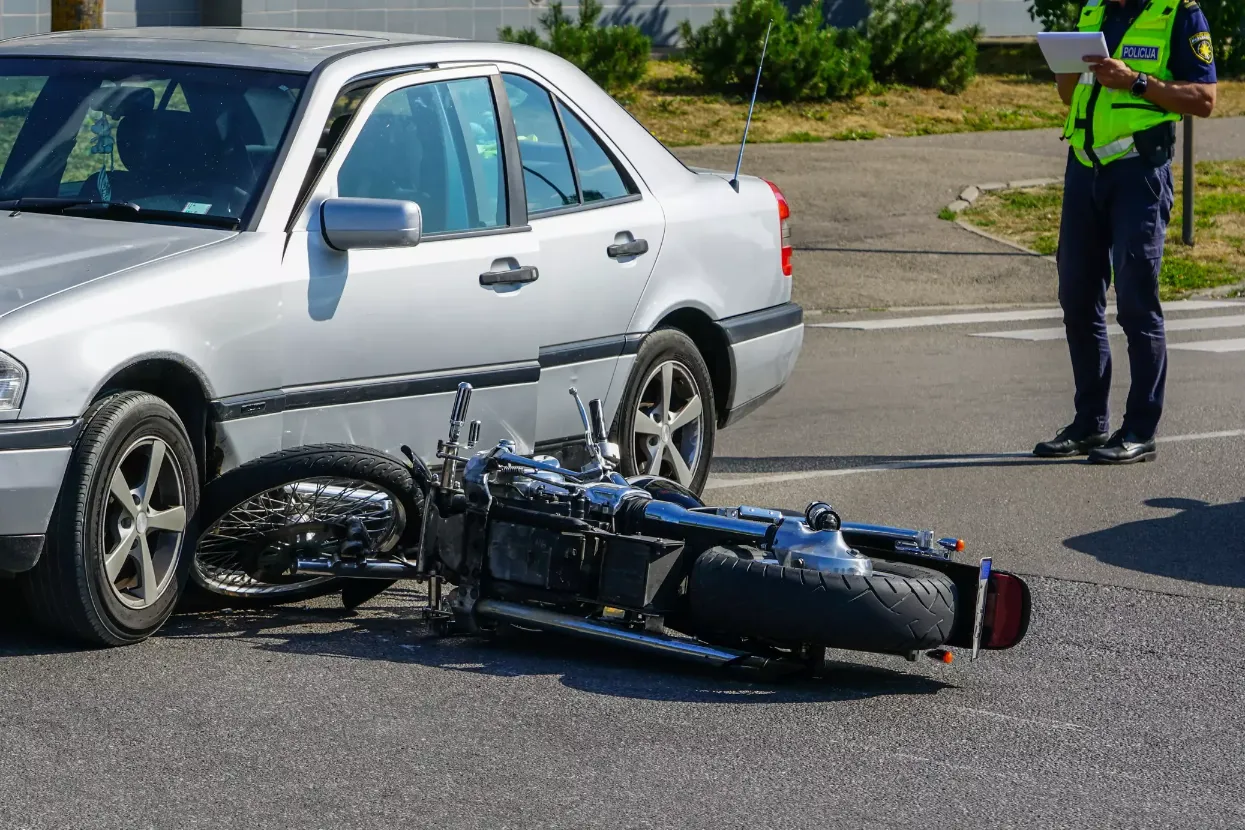 A motorcycle hit by a car.