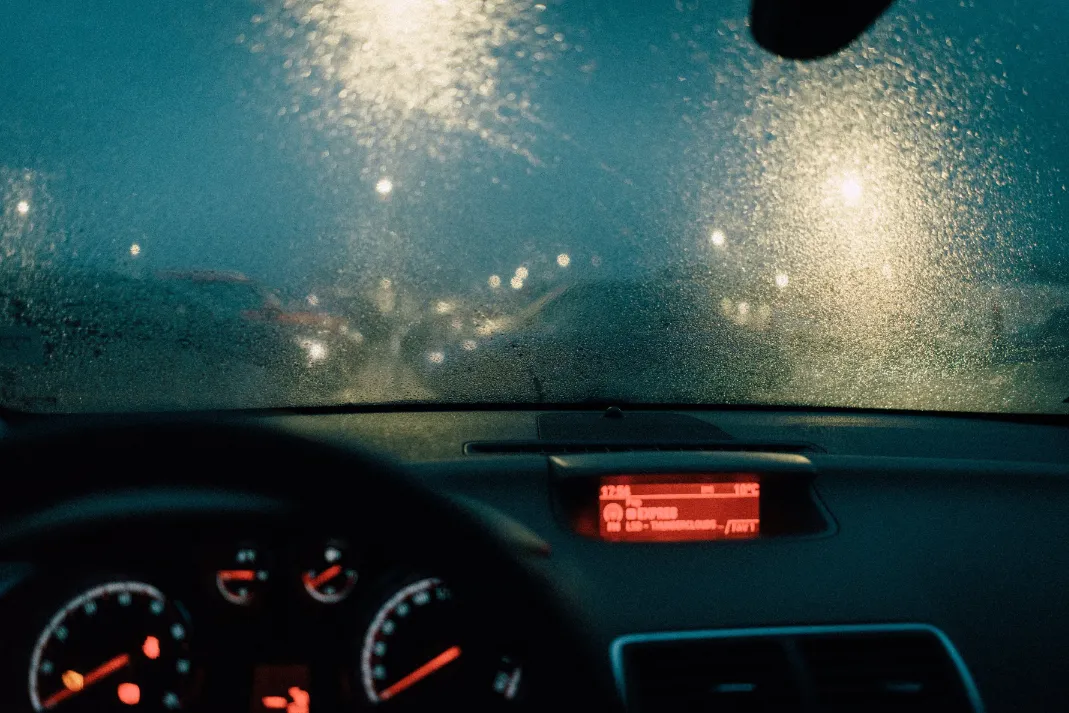 A car driving in the rain.
