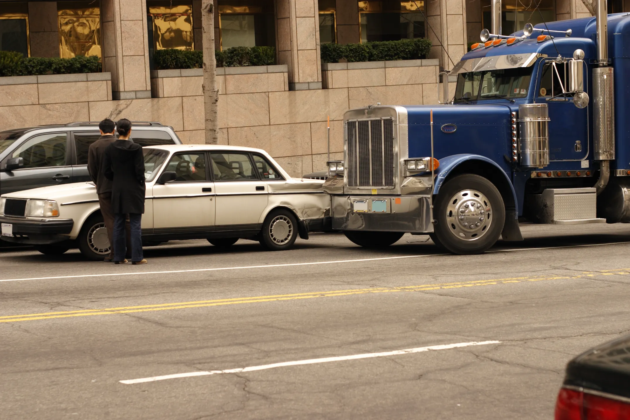 A car and commercial truck in an accident.