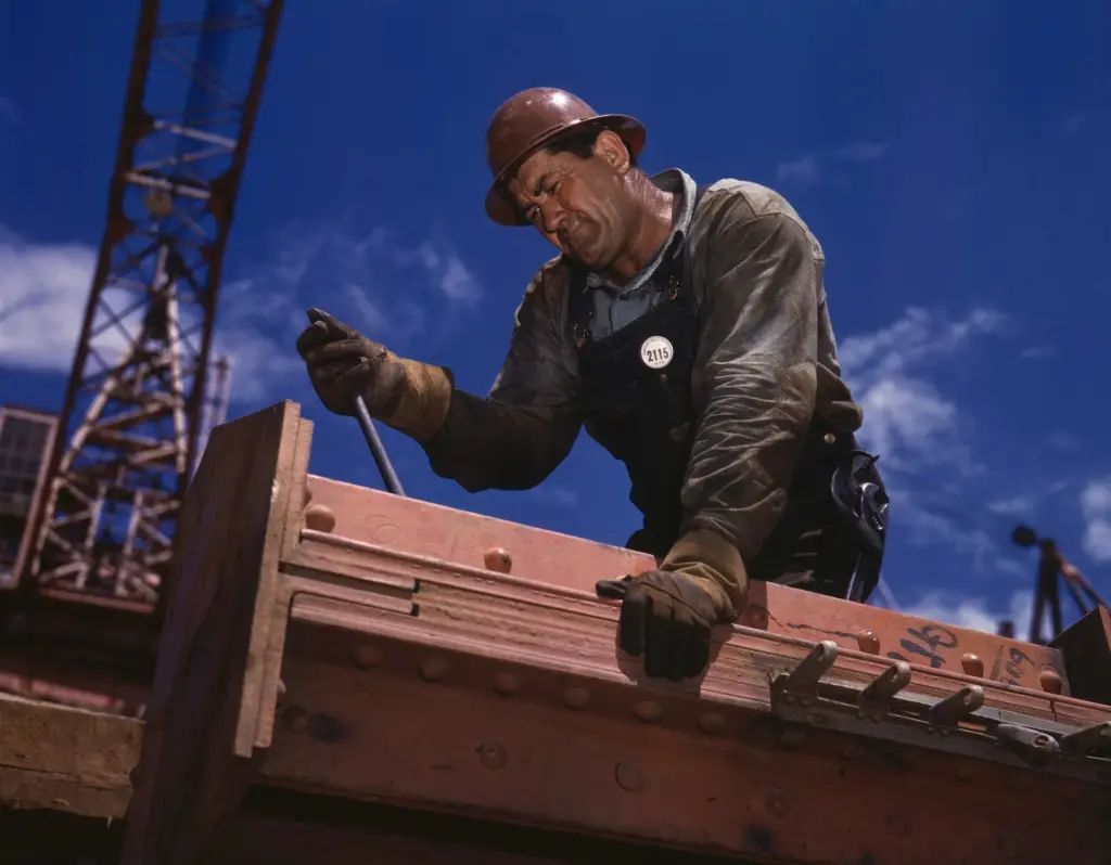 Construction worker on a high beam.