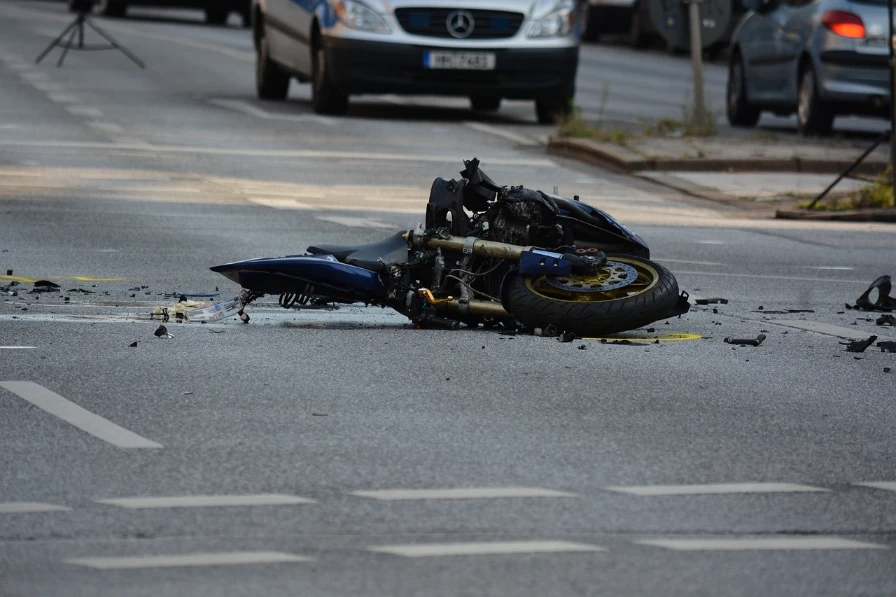 A motorcycle wrecked in the middle of a road.