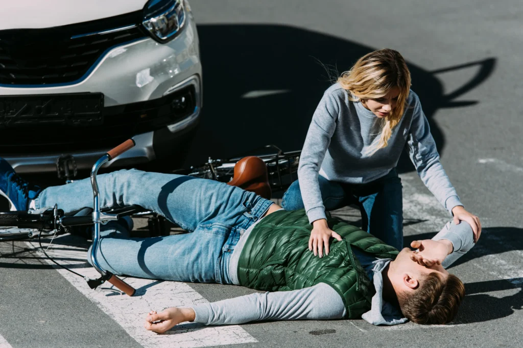 A man hit by a car on his bicycle.