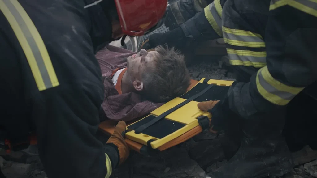 An electrocuted man on a stretcher.