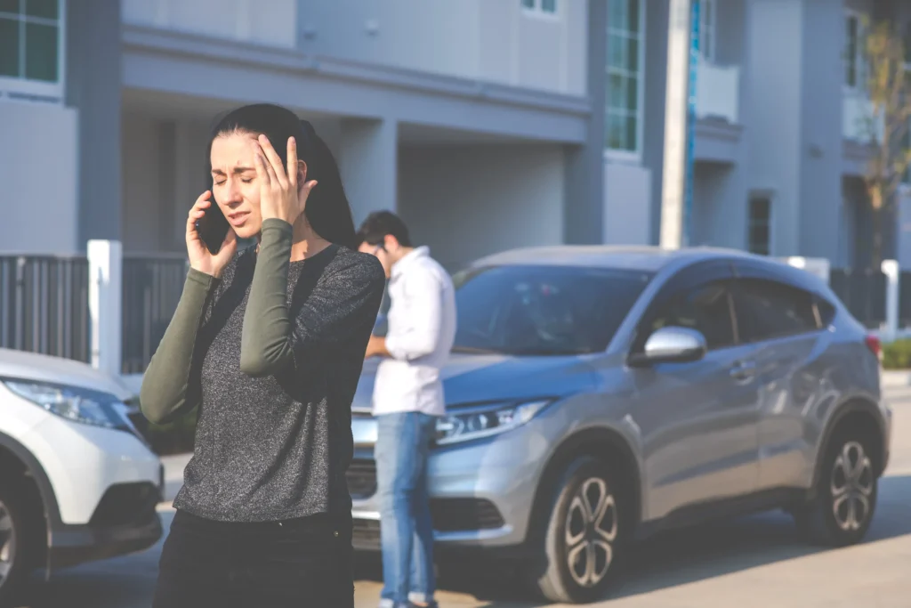 A woman calling the police after being injured in a rideshare accident.