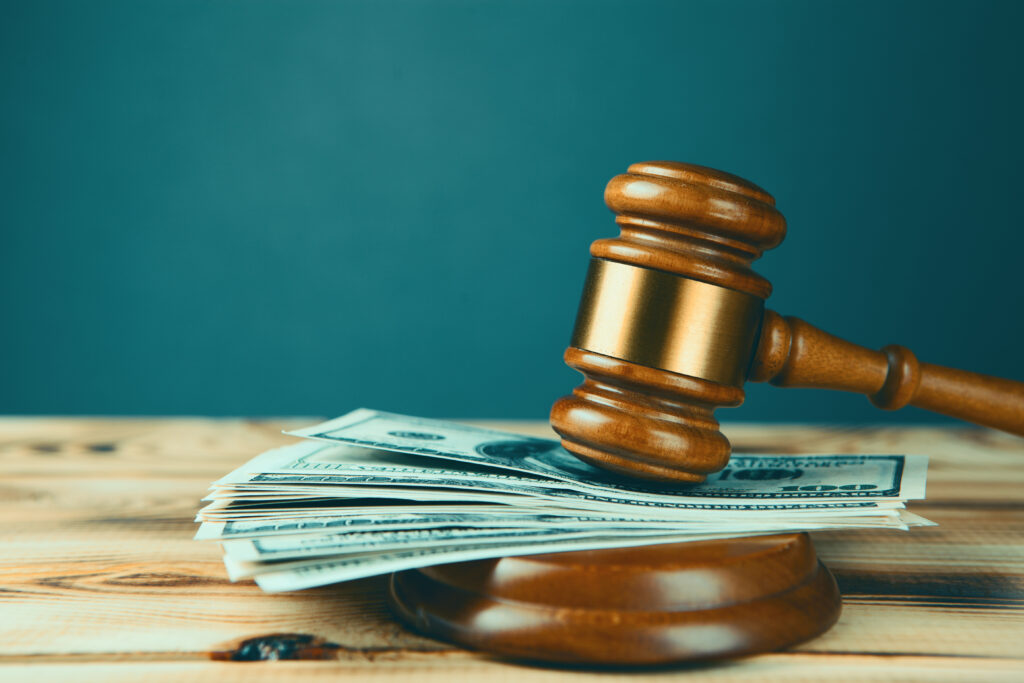 A gavel on top of money.